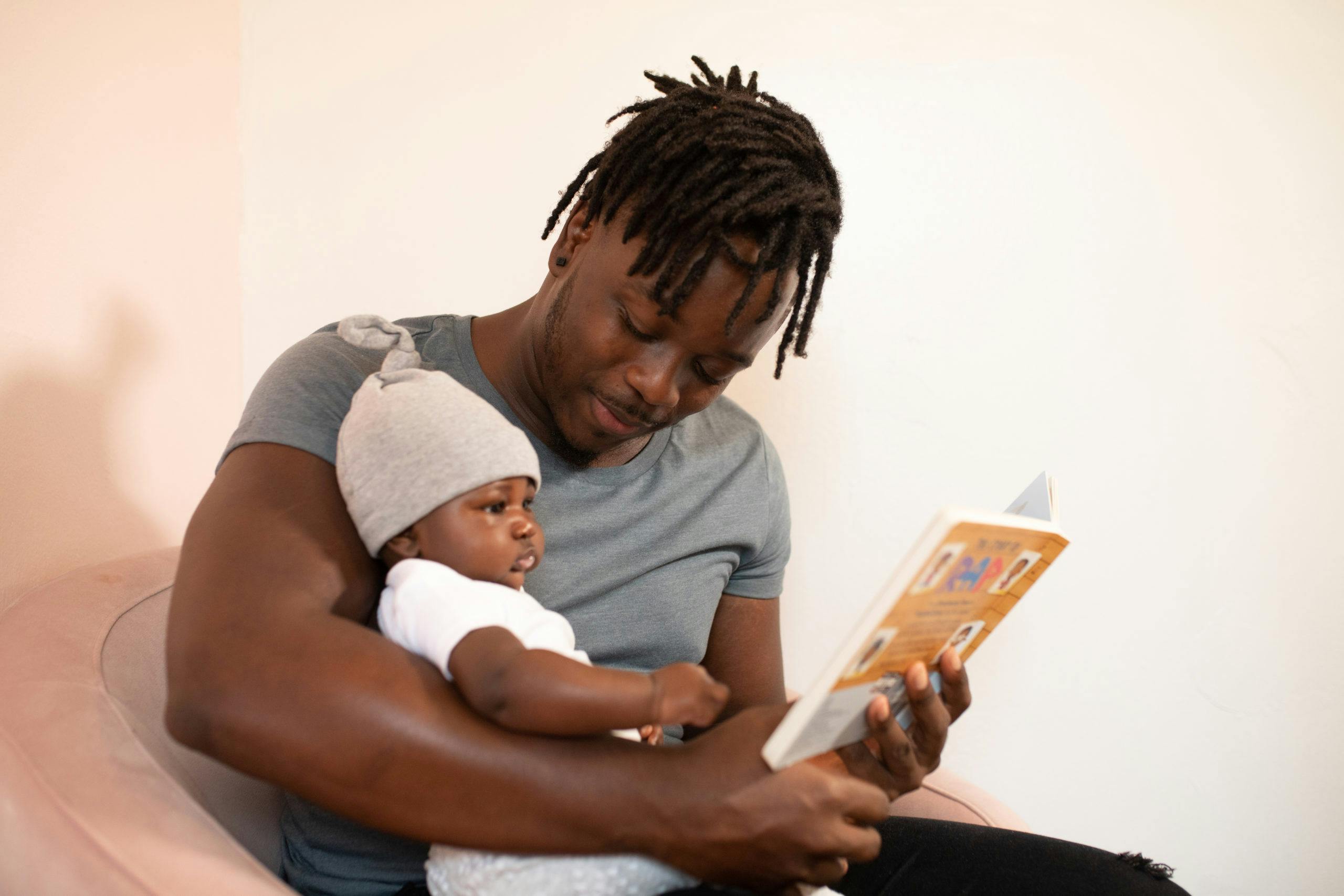 dad reading a book to his baby