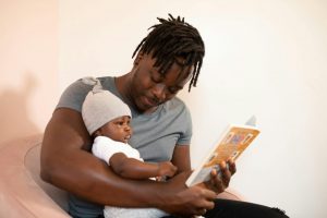 dad reading a book to his baby